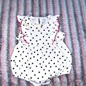 Beautiful white and black polk-a-dot romper with pink trimmings.